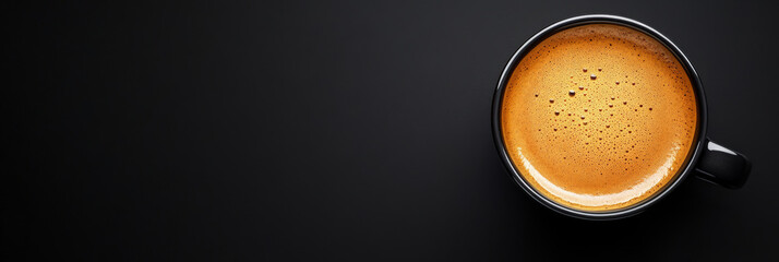 Top view of a fresh espresso in a turquoise cup on a textured dark stone surface, perfect for coffee lovers, cafe promotions, and minimalist designs