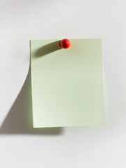 Minimalist Green Sticky Note with Red Pin on White Background - AI Generated