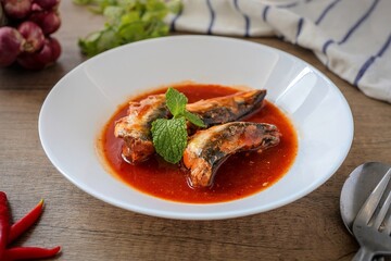 Sardines in tomaro sauce ,canned fish,Tinned fish in a white plate