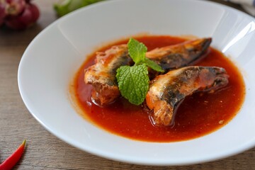 Close up of Sardines in tomaro sauce ,canned fish,Tinned fish in a white plate	