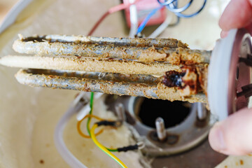 Limescale on the heating element of the water heater, scale is formed due to hot and hard water,...