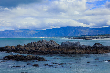 Stunning coastal landscape with rocky shore and mountains near the ocean in South Africa