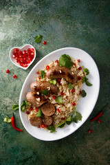 Homemade sausages with rice and pomegranate seeds