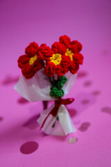 A bouquet of red knitted flowers on a beautiful background, a bouquet of red flowers, knitted flowers, knitted bouquets, handmade, knitted flowers, knitted gifts and toys