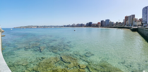 Panoramic view at the San Lorenzo beach, crystal clear and transparent waters, people on the beach, bathing area