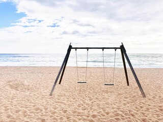 Children's swing on the beach.