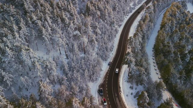 Snowy forest road aerial POV