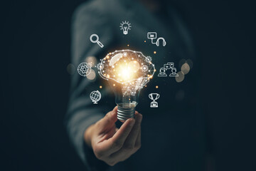Businessman holding a light bulb. The concept of generating ideas at work. New ideas. Ideas for managing financial systems and online marketing with cloud technology to link data online.