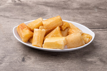 Traditional brazilian fried manioc in a plate over wooden table