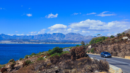 A scenic drive along the coast in South Africa with mountains and clear blue skies