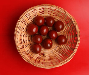 bowl of cherry tomatoes on red background
