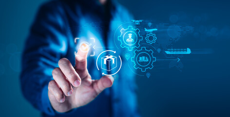 Man Pointing at Logistics Icons on Virtual Screen for Global Supply Chain Management