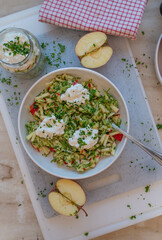 Healthy raw fruit vegetable salad with apples and zucchini topped with protein rich cottage cheese