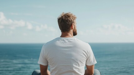 Man contemplates ocean view, peaceful coastal scene, travel blog