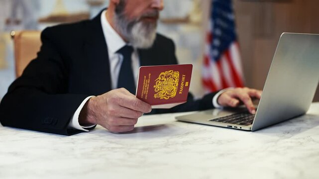 Senior consular service worker verifies United Kingdom passport data on a laptop