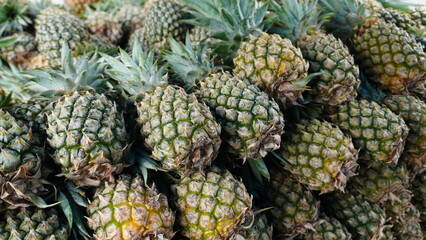 Fototapeta premium green pineapple fruit in pile