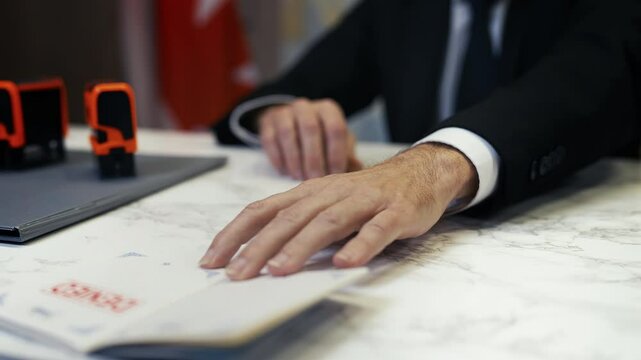Canadian customs officer stamps denied in a passport, refusing traveler's entry
