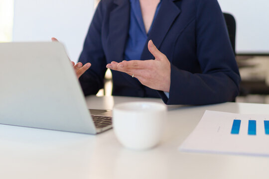 Young Asian businesswoman having a virtual meeting, discussing work while sitting in a professional office setting