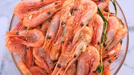 Seafood plating featuring fresh shrimp in garlic and herb sauce Highlighting seafood aroma and flavors perfect for gourmet dining or culinary inspiration Demonstration of seafood elegance and taste