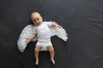 Little curious child with angel wings.