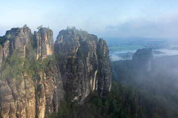 An early morning in mountain. Schrammsteine - group of rocks are a long, strung-out, very jagged in...