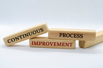Obraz premium Continuous Process Improvement text on wooden blocks with white background. Process Improvement concept
