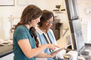 Doctor showing information on tablet to patient