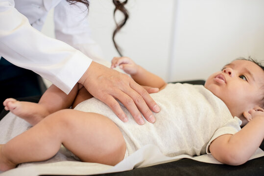 Close up of Doctor evaluating baby's tummy