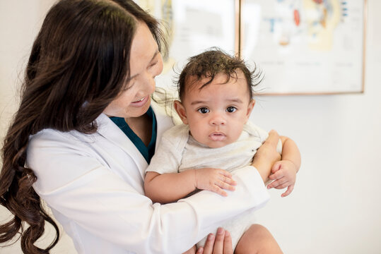 Close up of doctor holding baby infant