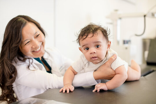 Doctor smiling at baby patient