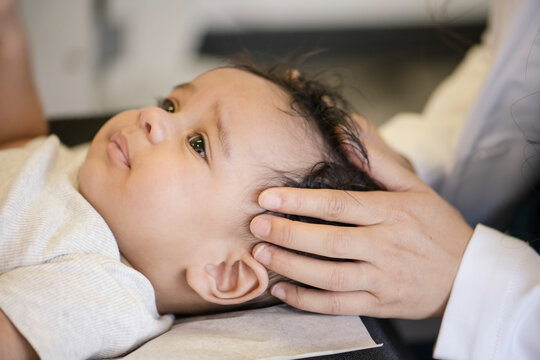 Close up of doctor evaluating baby's head