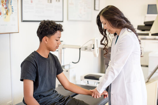 Woman doctor evaluating young patient