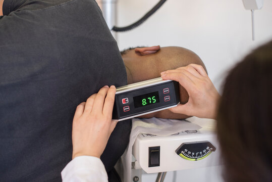 Doctor measuring the patients neck atlas