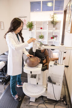 Doctor using equipment on male patient