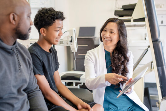 Doctor showing patients information on tablet