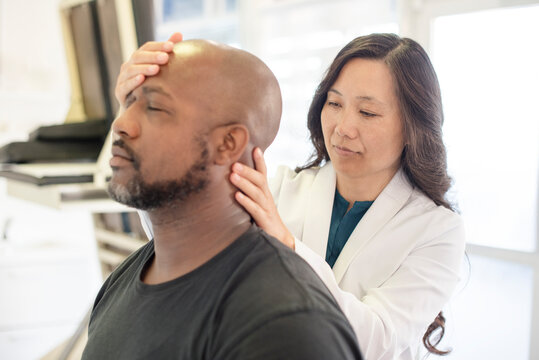 Doctor looking at patients neck