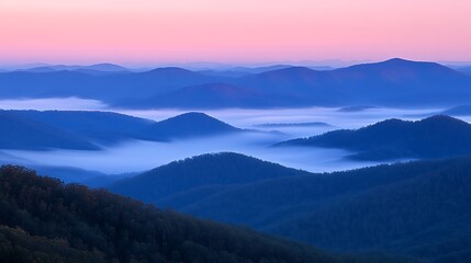 Fototapeta premium A misty mountain range with layers of hills fading into the distance, bathed in the soft light of dawn 