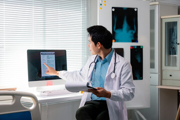 Doctor analyzing patient information form on computer screen, holding medical records in hand, in...