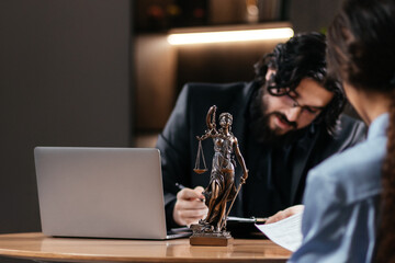 Successful Attorney Lawyer Fight for Freedom of Her Client with Supporting Evidence. lawyer using a laptop, computer in a courtroom setting with scales of justice. Court of Justice and Law Trial.
