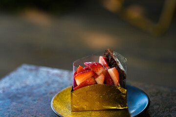 Chocolate Cake Slice with Fresh Strawberries on a Rustic Plate