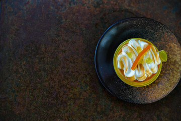 Orange meringue tart on a rustic plate.