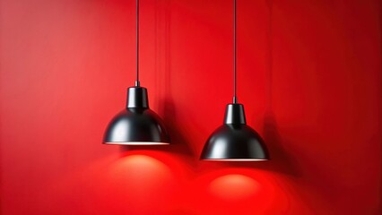 Obraz premium Two Matte Black Pendant Lights Against a Vibrant Red Wall