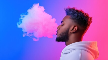 Young Man Exhaling Colorful Vapor Against a Vivid Pink and Blue Studio Background