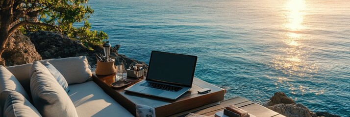 Laptop and coffee with ocean view outdoor workspace.