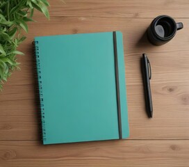 Overhead view of a teal notebook and pen on a wooden desk, desk, pen, teal