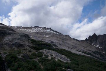 View of Cerro Lopez rocky mountain and Patagonian forest in Bariloche, under a beautiful summer sky with clouds