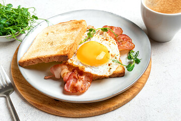 Healthy breakfast. Toast with fried egg, bacon and microgreens