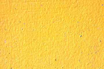 The walls of a house are painted bright yellow.