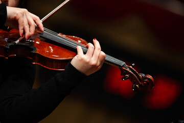  Close-up of a woman's hands playing the violin