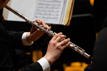 Hands of a musician playing the flute